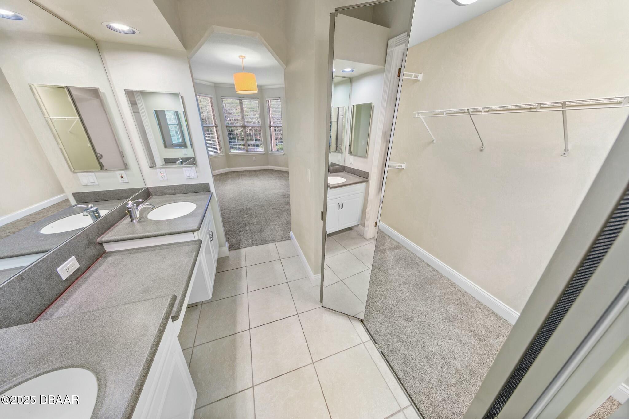 4623 Rivers Edge Village Lane, Unit 6204 Ponce Inlet, FL 32127 - Photo 17 of 51 a bathroom with a glass door shower a sink and a toilet