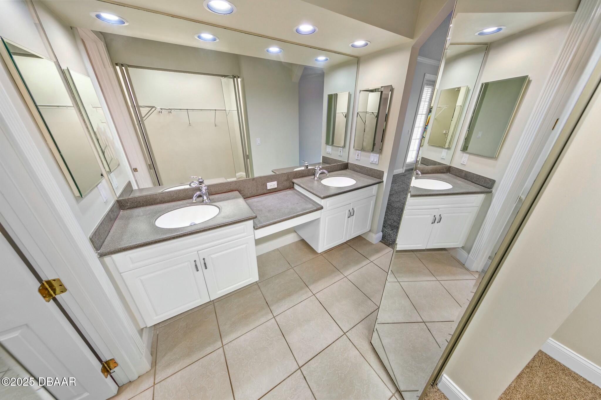 4623 Rivers Edge Village Lane, Unit 6204 Ponce Inlet, FL 32127 - Photo 18 of 51 a bathroom with a sink a mirror and a shower