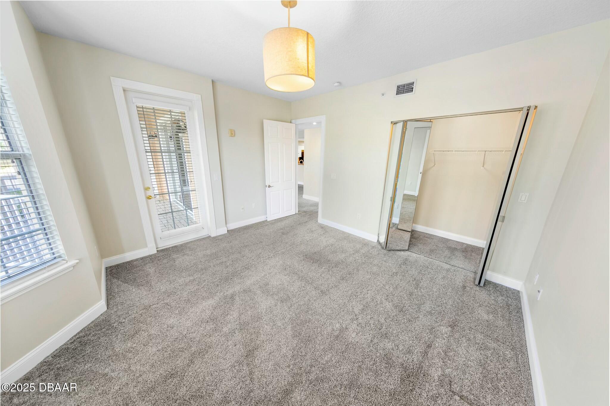4623 Rivers Edge Village Lane, Unit 6204 Ponce Inlet, FL 32127 - Photo 23 of 51 an empty room with windows and entrance