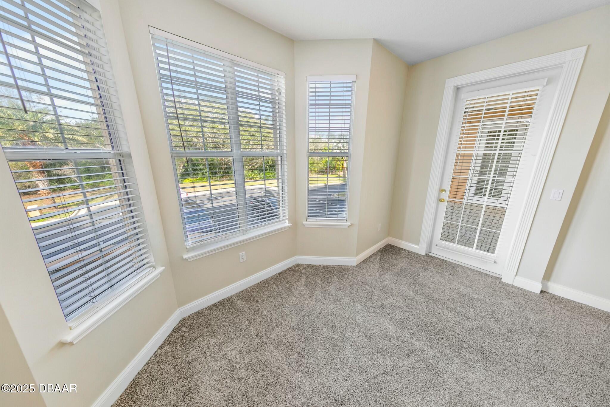 4623 Rivers Edge Village Lane, Unit 6204 Ponce Inlet, FL 32127 - Photo 24 of 51 a view of an empty room with a balcony