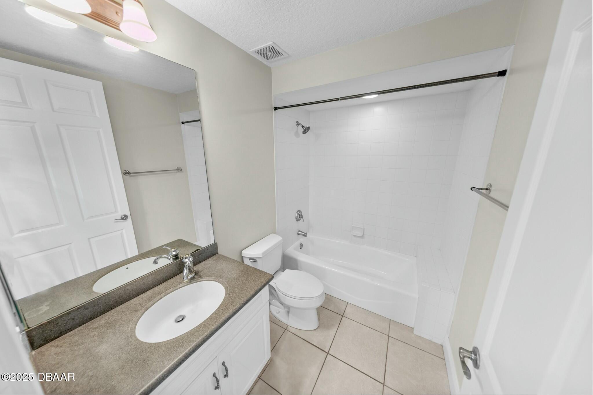 4623 Rivers Edge Village Lane, Unit 6204 Ponce Inlet, FL 32127 - Photo 25 of 51 a bathroom with a granite countertop sink toilet and shower