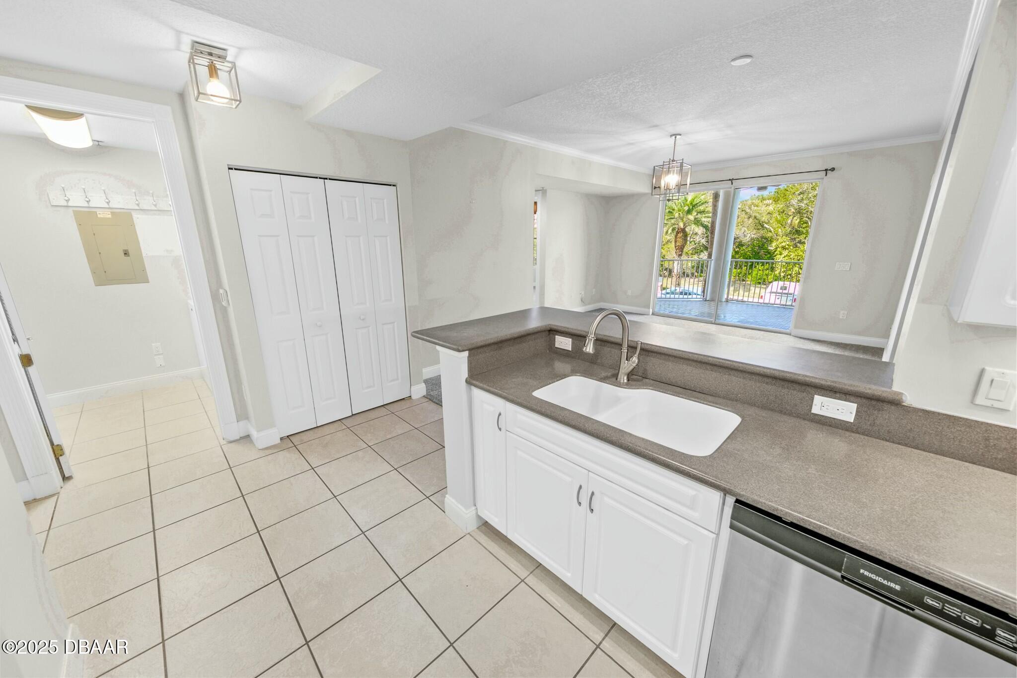 4623 Rivers Edge Village Lane, Unit 6204 Ponce Inlet, FL 32127 - Photo 9 of 51 a kitchen with a sink cabinets and window