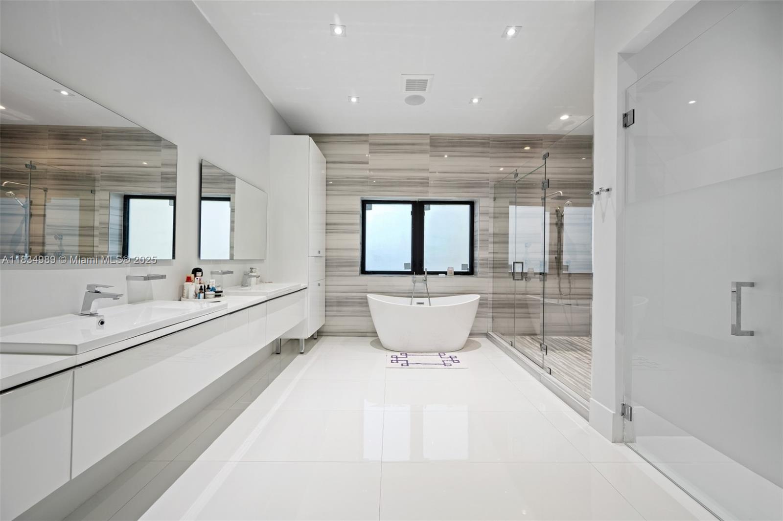 11350 Northwest 8th Street Plantation, FL 33325 - Photo 24 of 68 a bathroom with a double vanity sink and mirror