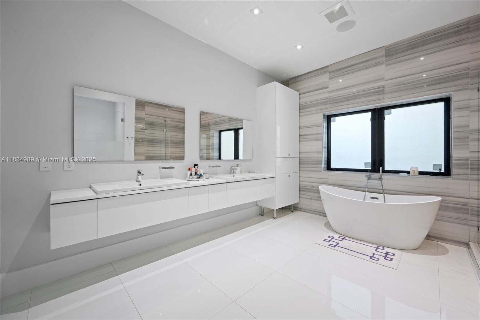 11350 Northwest 8th Street Plantation, FL 33325 - Photo 25 of 68 a bathroom with a large tub sink and mirror