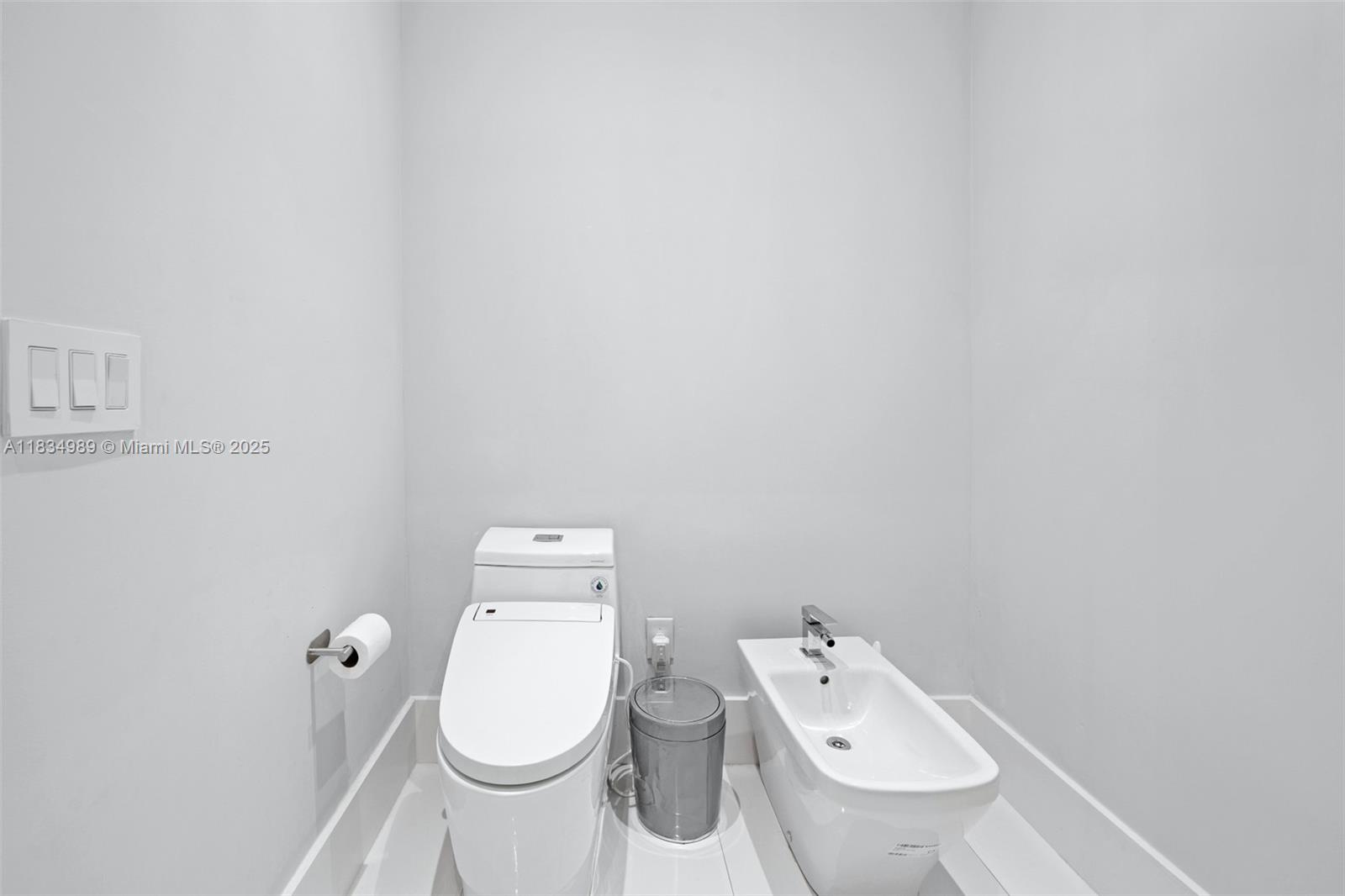 11350 Northwest 8th Street Plantation, FL 33325 - Photo 27 of 68 a white toilet sitting next to a white sink