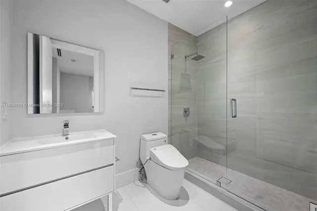 a bathroom with a toilet sink shower and mirror
