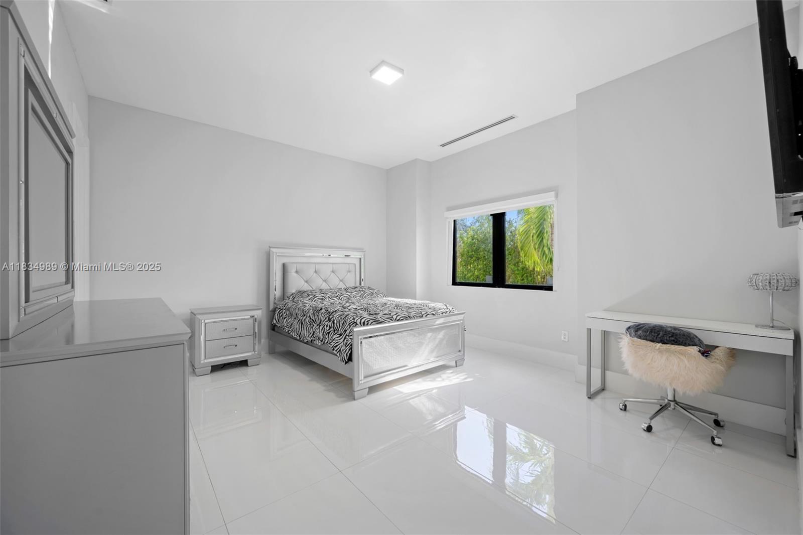 11350 Northwest 8th Street Plantation, FL 33325 - Photo 37 of 68 a bedroom with a bed and a table in it