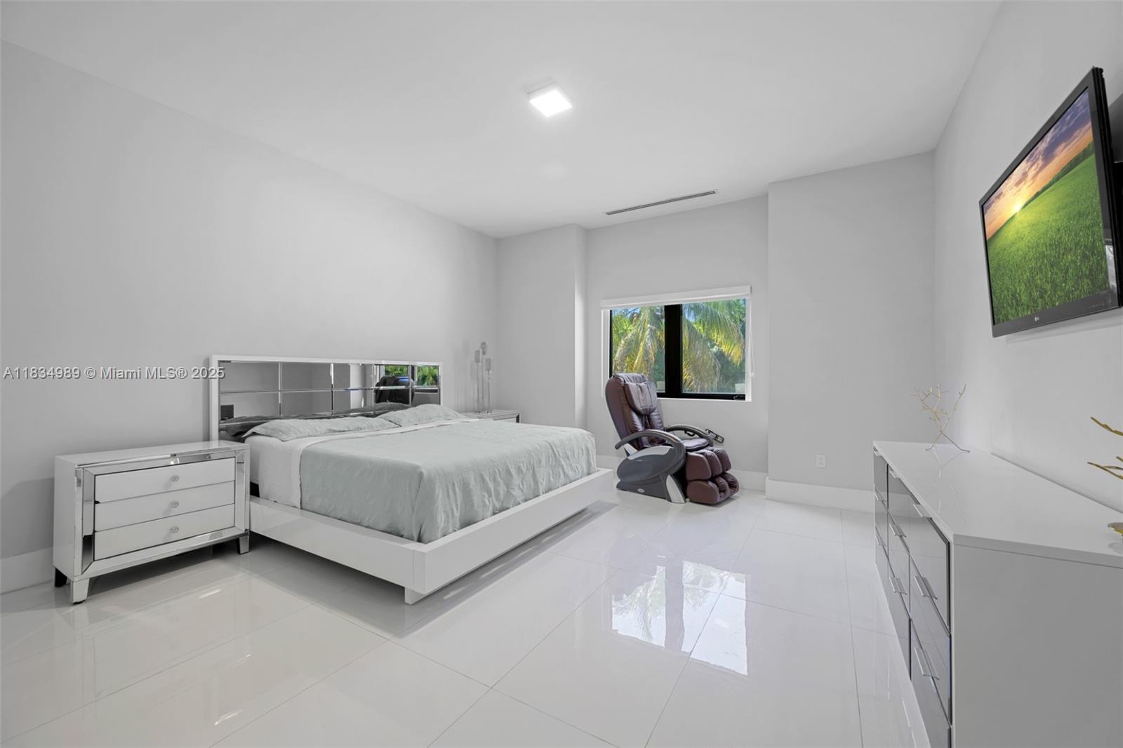 11350 Northwest 8th Street Plantation, FL 33325 - Photo 41 of 68 a bedroom with a bed and a flat screen tv