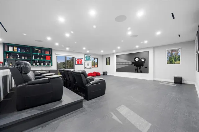 an aerial view of residential houses with outdoor space and trees