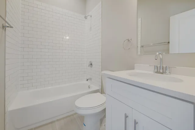 a bathroom with a sink a toilet and bathtub