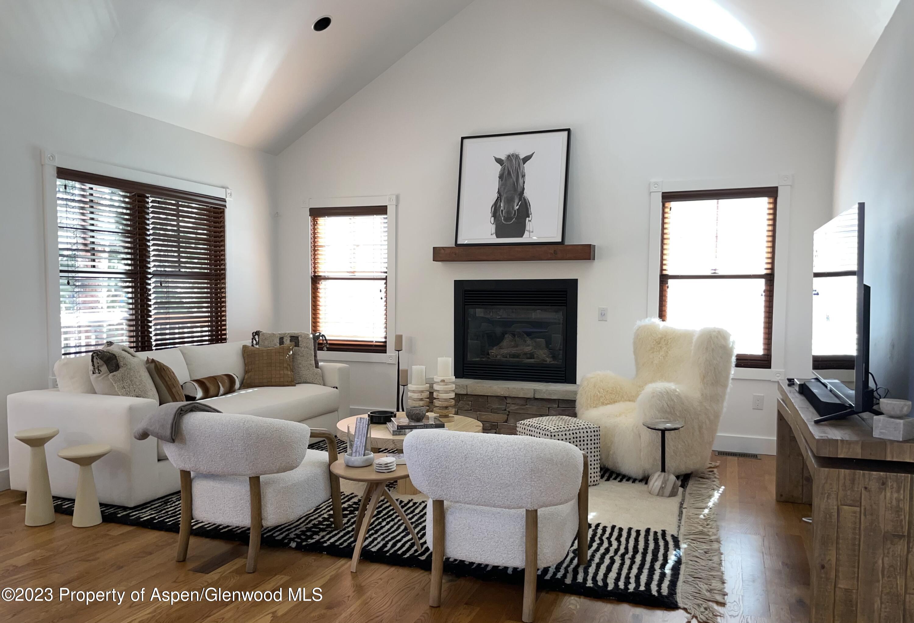 a living room with furniture a fireplace and a table