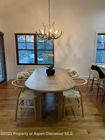 a view of a dining room with furniture and wooden floor
