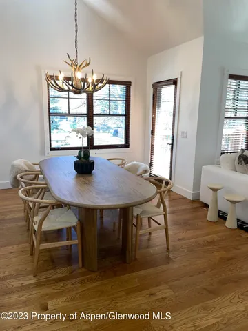a view of a dining room with furniture window and wooden floor