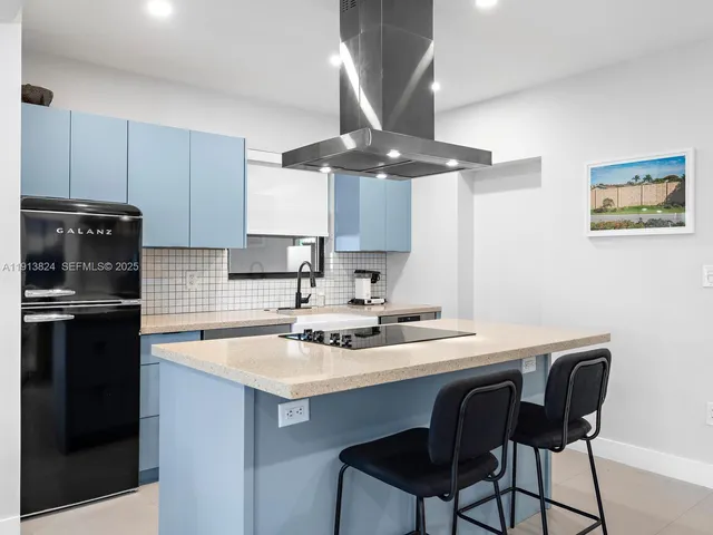 a kitchen with a sink cabinets and stainless steel appliances