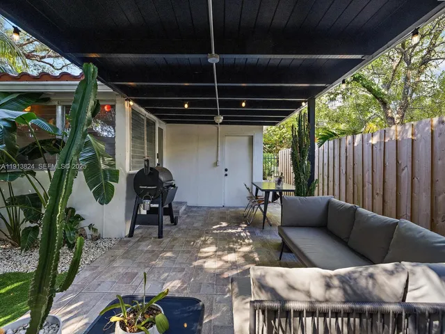 a building outdoor space with patio furniture and potted plants