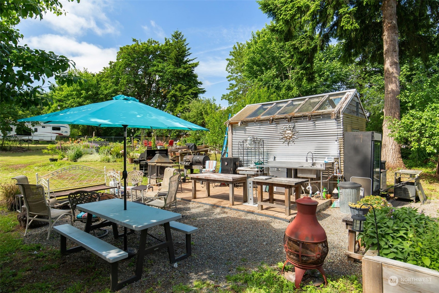1497 Old Military Road Southeast Tenino, WA 98589 - Photo 28 of 39 a view of a patio with table and chairs under an umbrella