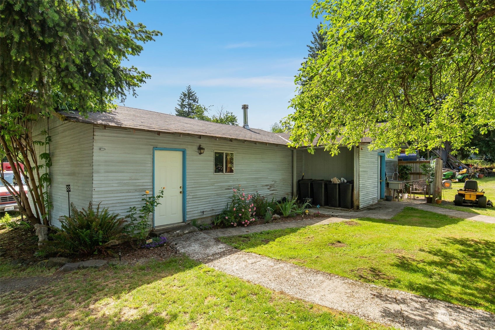1497 Old Military Road Southeast Tenino, WA 98589 - Photo 29 of 39 a view of a backyard with table and chairs under an umbrella