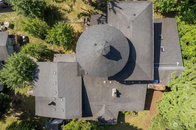 an aerial view of a house with outdoor space and swimming pool