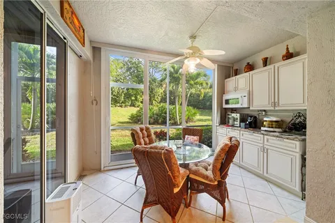 a dining room with furniture a chandelier and fireplace