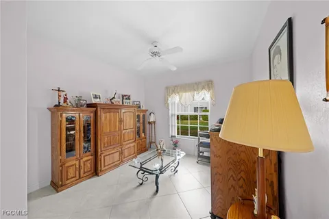 a living room with furniture a window and gym equipment