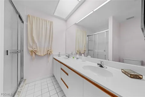 a bathroom with a double vanity sink and a mirror