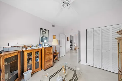 a living room with stainless steel appliances kitchen island granite countertop a refrigerator and cabinets