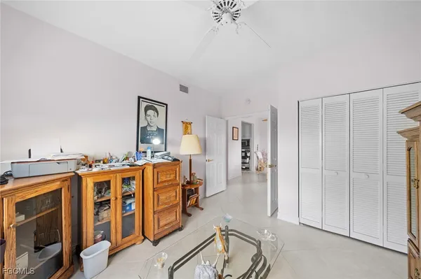 a living room with stainless steel appliances kitchen island granite countertop a refrigerator and cabinets