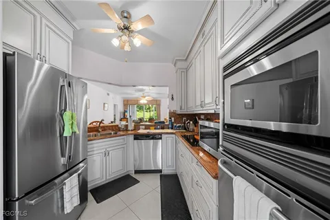 a kitchen with a sink stainless steel appliances and cabinets