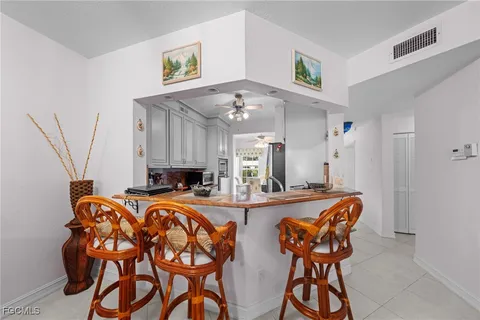 a view of a dining room with furniture and a chandelier