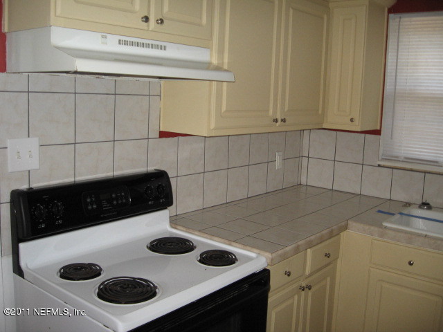 7189 Balboa Road Jacksonville, FL 32217 - Photo 4 of 13 a kitchen with a sink and cabinets