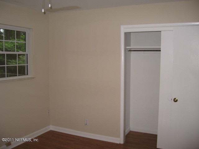 7189 Balboa Road Jacksonville, FL 32217 - Photo 8 of 13 a view of an empty room with wooden floor and a window