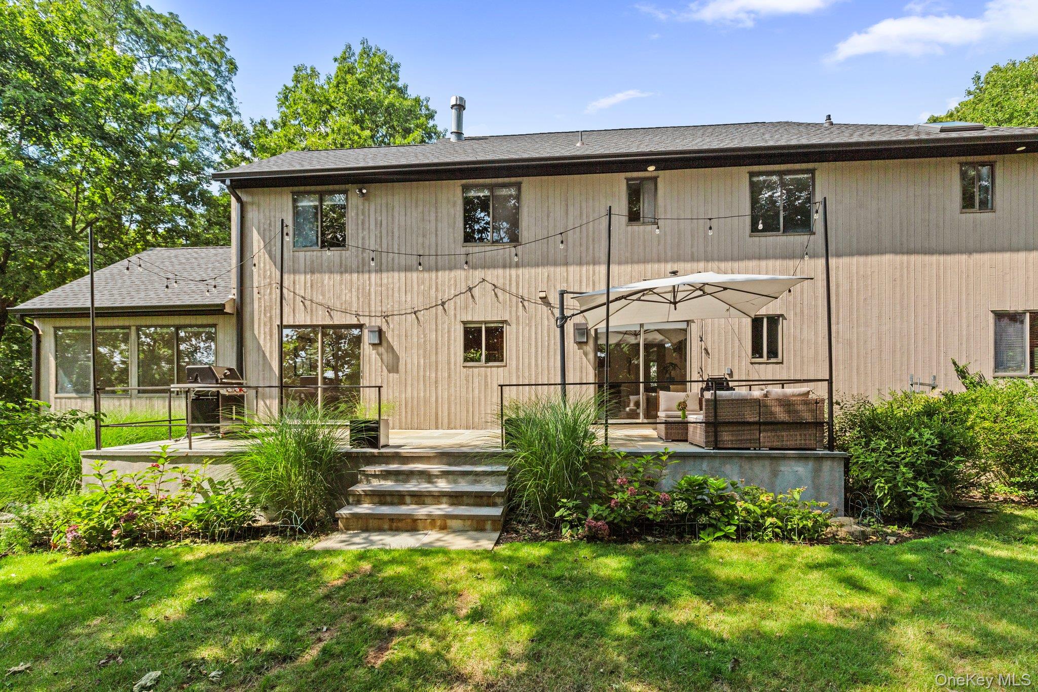 27 Stone Cabin Road New Rochelle, NY 10801 - Photo 18 of 24 Back of property with a lawn and a deck