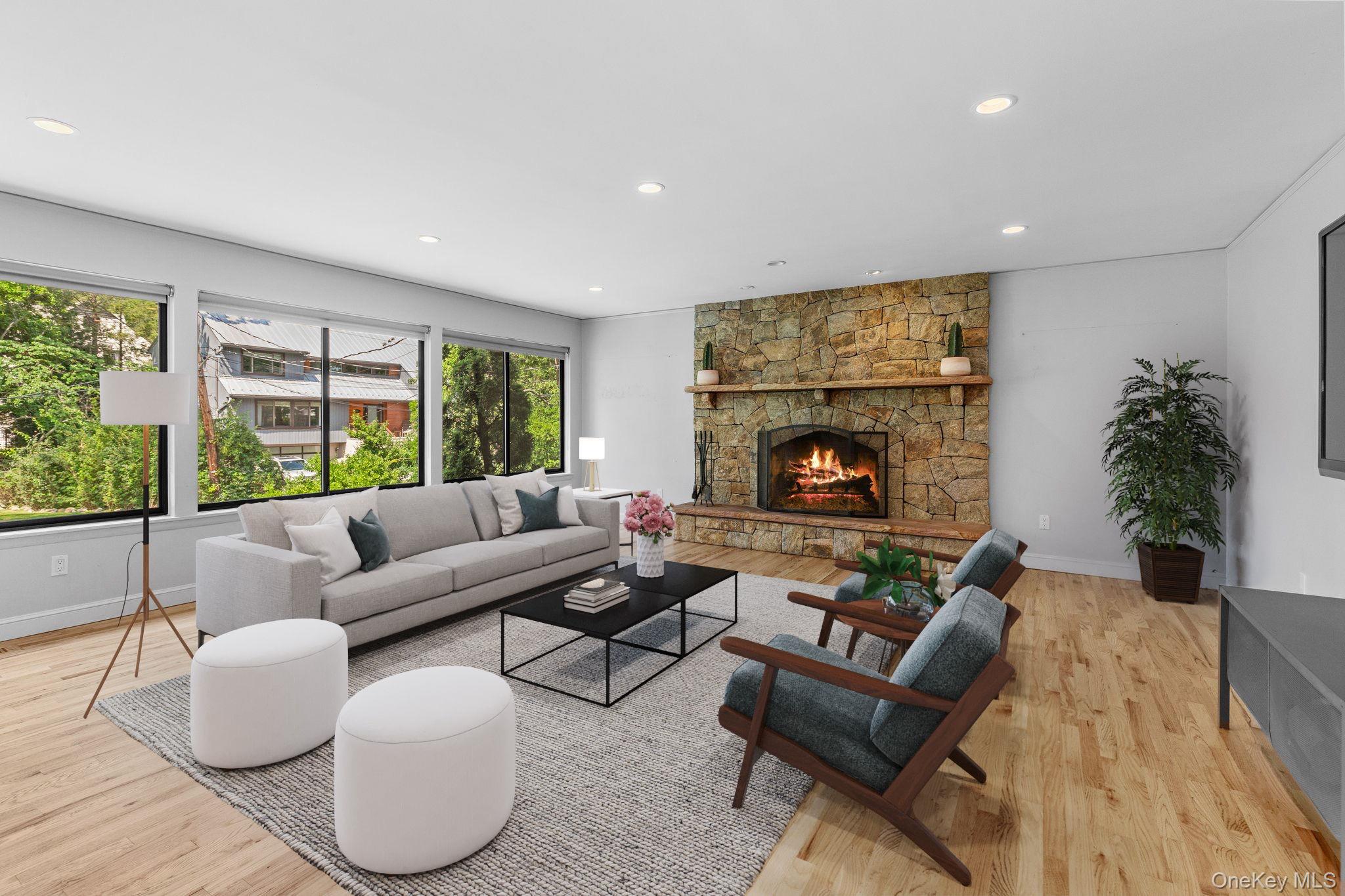 27 Stone Cabin Road New Rochelle, NY 10801 - Photo 6 of 24 Living room with recessed lighting, light wood-style floors, and a stone fireplace (virtually staged)