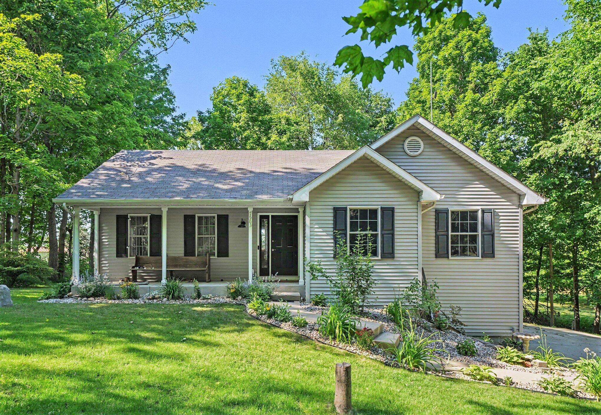 7563 East 400 North Rolling Prairie, IN 46371 - Photo 1 of 17 a view of a house with garden and yard