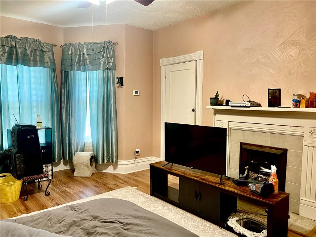 224 West Pearl Street Butler, PA 16001 - Photo 17 of 30 a bedroom with a bed and a fireplace