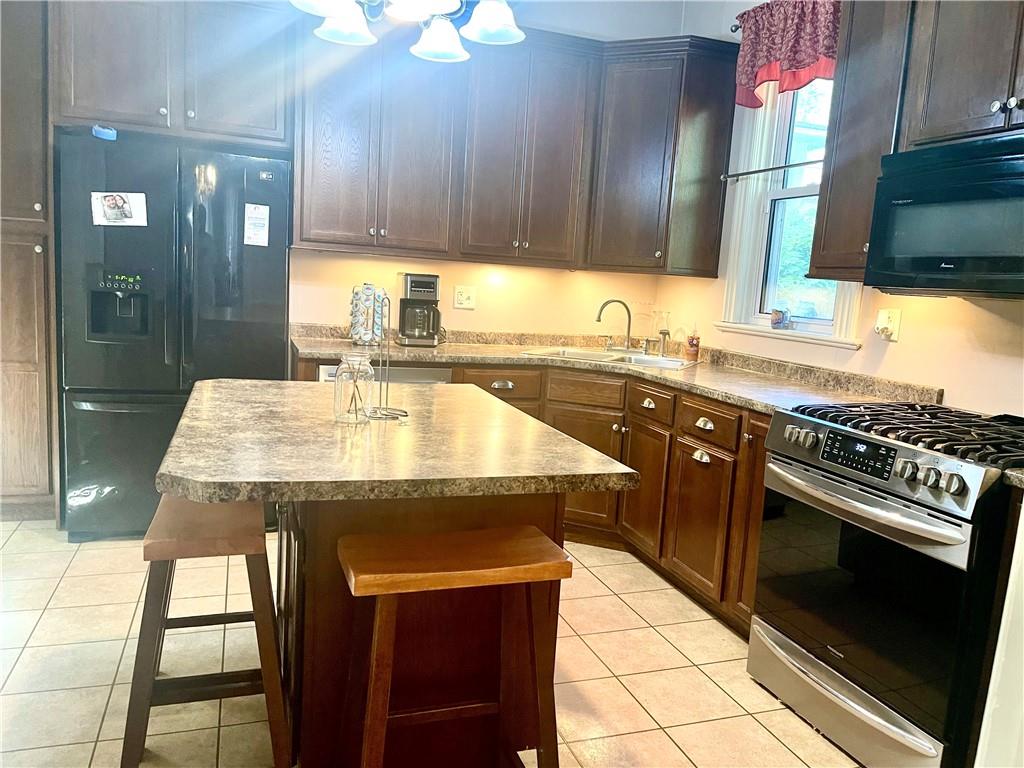 224 West Pearl Street Butler, PA 16001 - Photo 5 of 30 a kitchen with a stove a sink and a microwave
