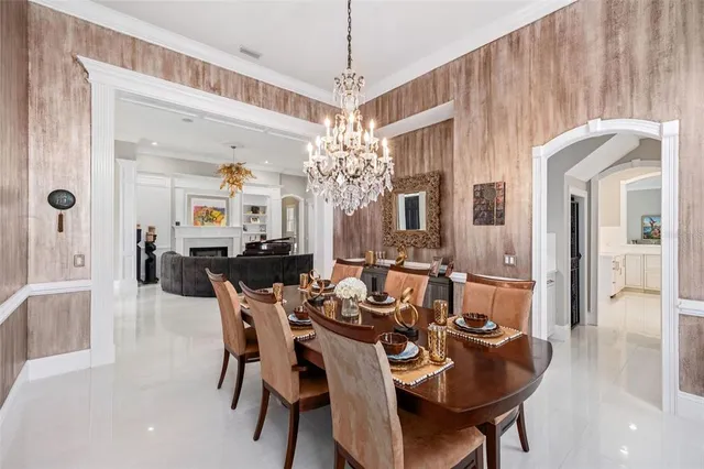 a living room with furniture cabinets and a large window