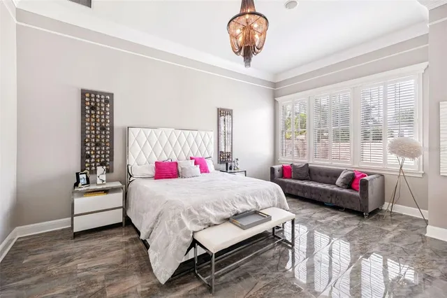 a bedroom with a bed and a chandelier