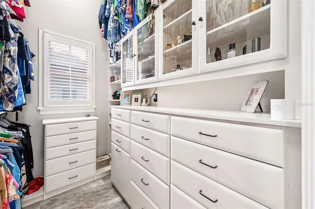 a spacious bathroom with a granite countertop double vanity sink a mirror a bathtub and