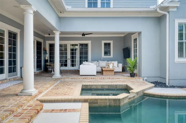 a swimming pool with outdoor seating and yard