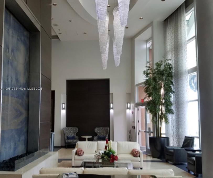 1155 Brickell Bay Drive, Unit 705 Miami, FL 33131 - Photo 18 of 20 a living room with furniture and a potted plant