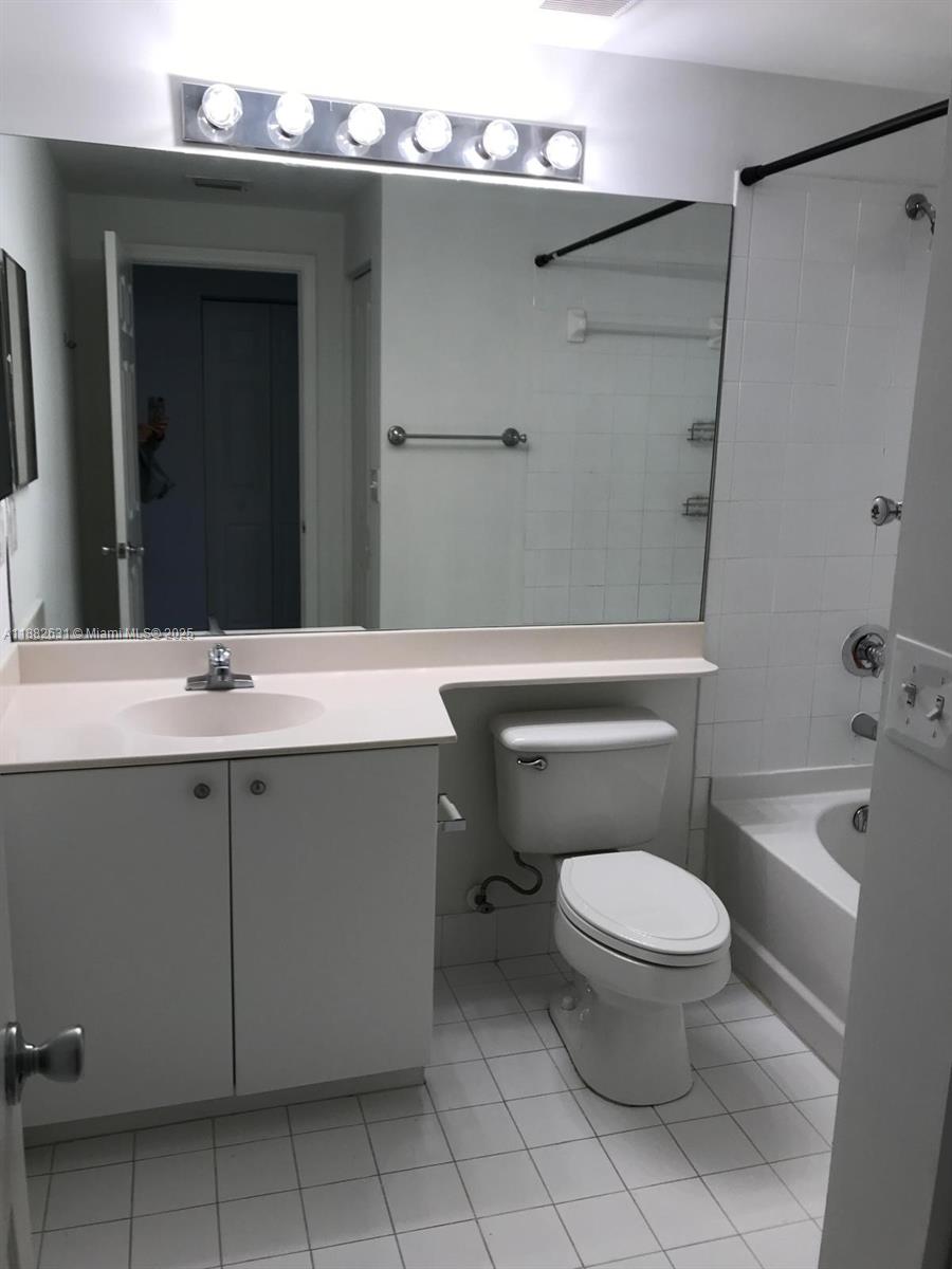 5820 West Sample Road, Unit 201 Coral Springs, FL 33067 - Photo 13 of 14 a bathroom with a sink toilet and shower