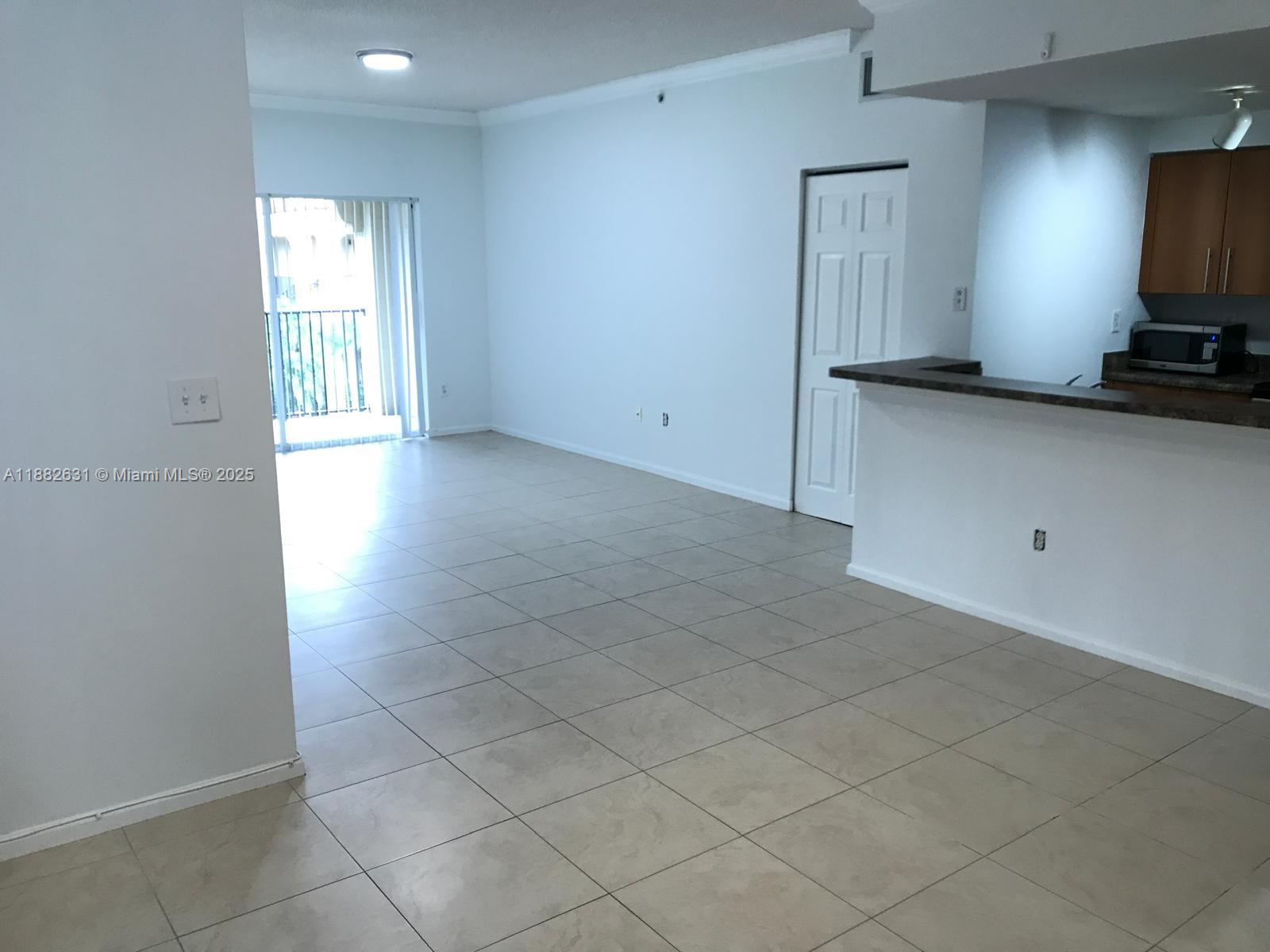 5820 West Sample Road, Unit 201 Coral Springs, FL 33067 - Photo 2 of 14 a view of a kitchen with a sink and a window