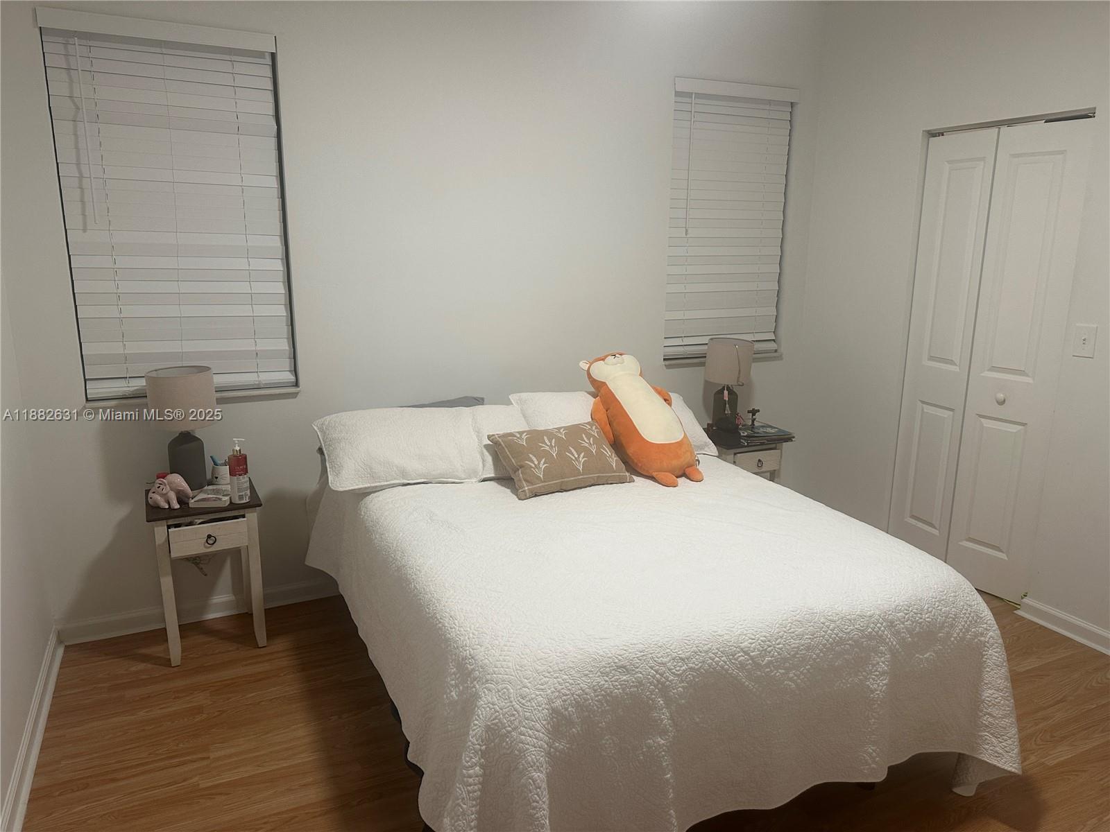 5820 West Sample Road, Unit 201 Coral Springs, FL 33067 - Photo 6 of 14 a bedroom with a bed and a chair