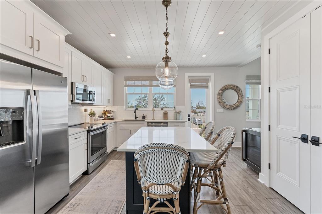 4357 Marina Vw Way Cortez, FL 34215 - Photo 23 of 59 a large kitchen with a table and chairs in it