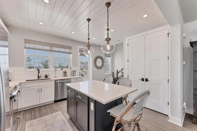 a kitchen with cabinets and stainless steel appliances