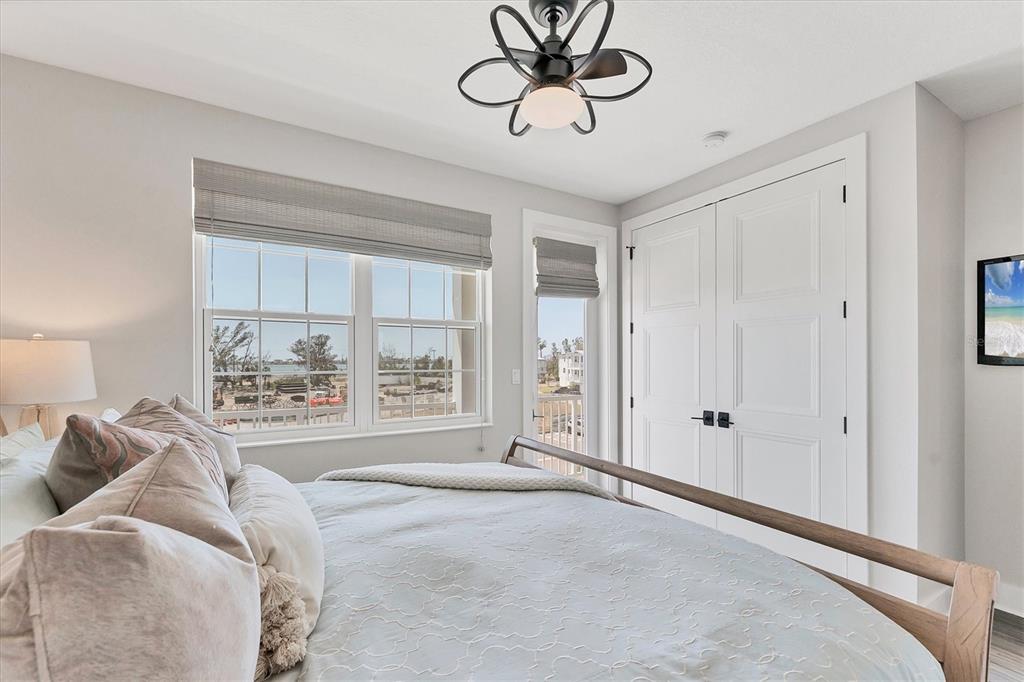 4357 Marina Vw Way Cortez, FL 34215 - Photo 40 of 59 a bedroom with a bed and a chandelier