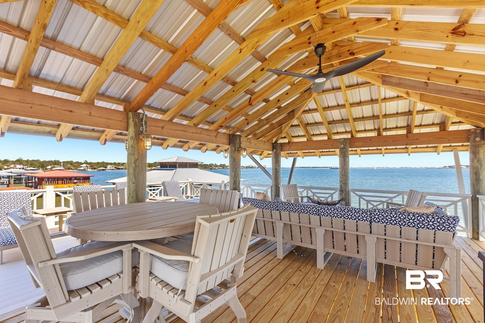 6434 County Road 95 Elberta, AL 36530 - Photo 68 of 99 Wooden terrace with a water view, outdoor dining area, and ceiling fan