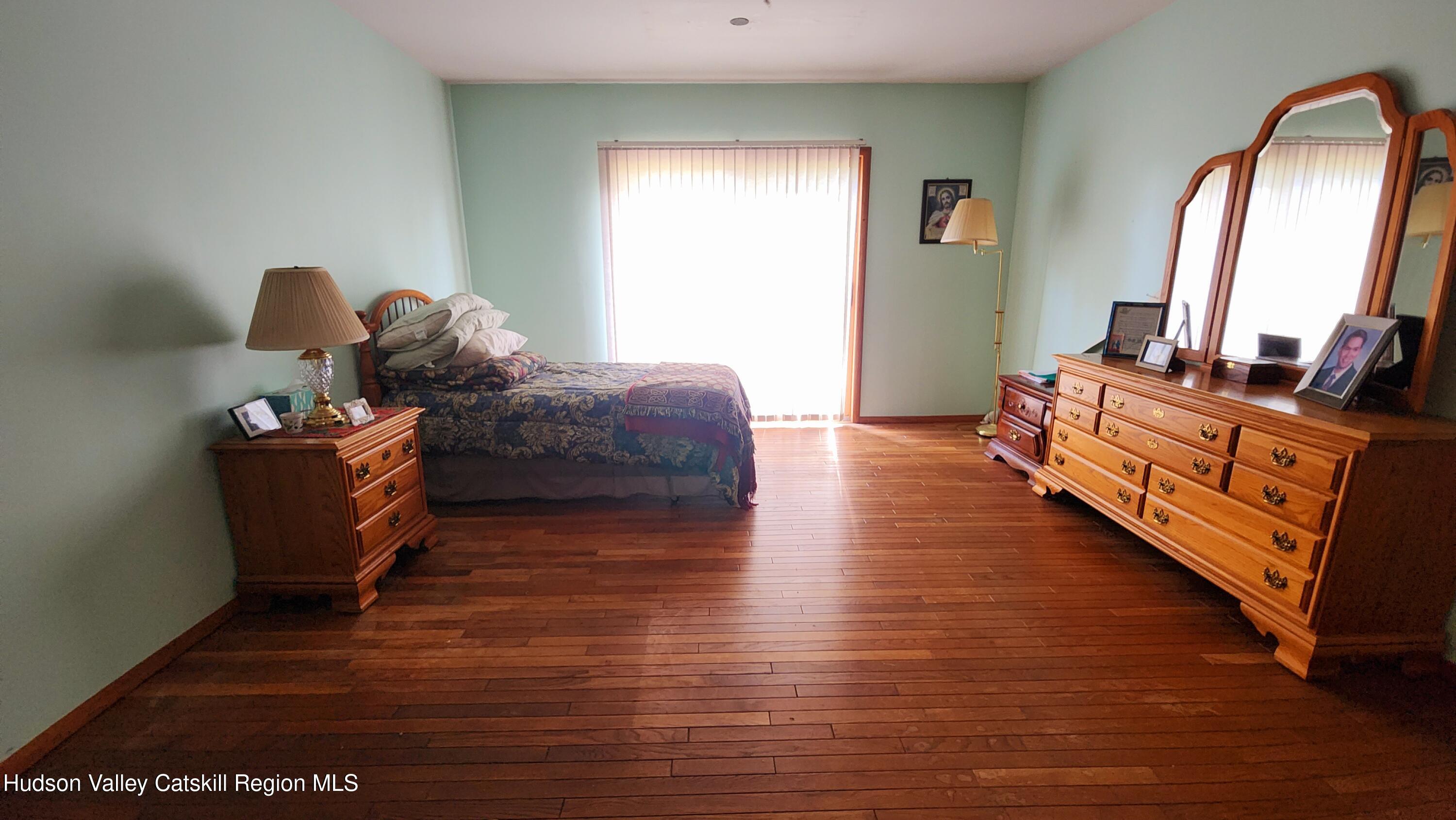 17 Clay Hill Road Durham, NY 12423 - Photo 12 of 15 a bed room with furniture and a mirror