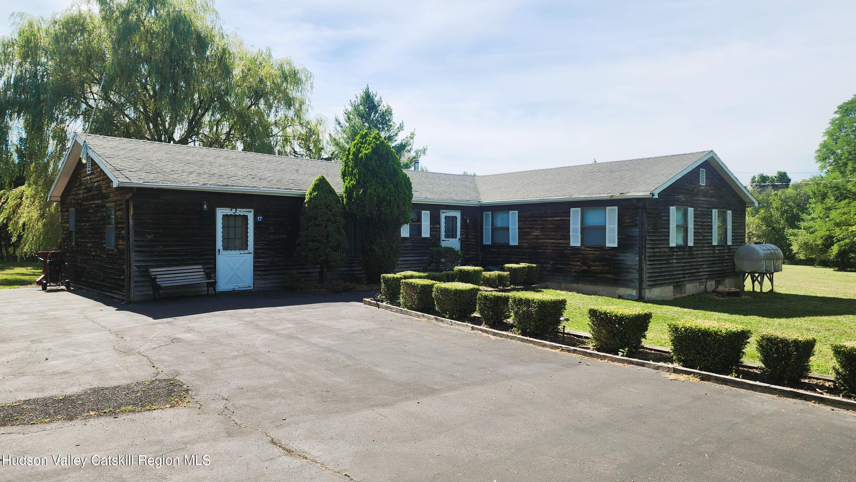 17 Clay Hill Road Durham, NY 12423 - Photo 15 of 15 a front view of a house with porch and a yard